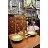 A set of antique brass balance scales, by Attwood, 54cm high.