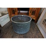 An antique Victorian copper cauldron, with swing handle, the cauldron 45cm diameter.