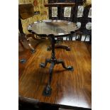 (THH) A small antique carved mahogany tripod table, 40cm wide.