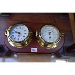 A combined brass clock and barometer set, by Sewills, the whole 35cm wide.