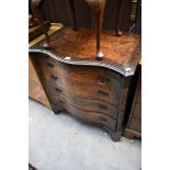 A 1920s burr walnut and crossbanded serpentine fronted chest, 76cm wide.