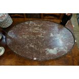 A large marble oval table top, with pierced brass gallery, 110.5cm wide.