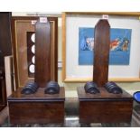A pair of mahogany and ebonized plate stands, 44cm high.