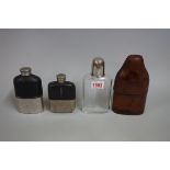 Three various glass hip flasks, one with leather outer case.