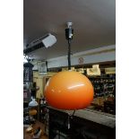 A 1970s Guzzini style orange globe 'rise and fall' ceiling light.