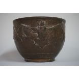 An Oriental bronze jar, relief moulded with bats, 12.5cm diameter, (lacking cover).