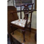 An early 20th century mahogany child's elbow chair.