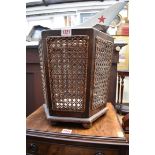 A 1920s mahogany and cane hexagonal waste paper bin, 32cm high.