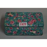 A Chinese enamel rectangular box and cover, decorated with flowers against a blue ground, 15.5cm