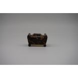 A miniature early 19th century tortoiseshell sarcophagus box, 5.7cm wide.