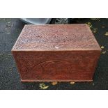 A carved trunk having brass handles.This lot can only be collected on Saturday 19th December (9-
