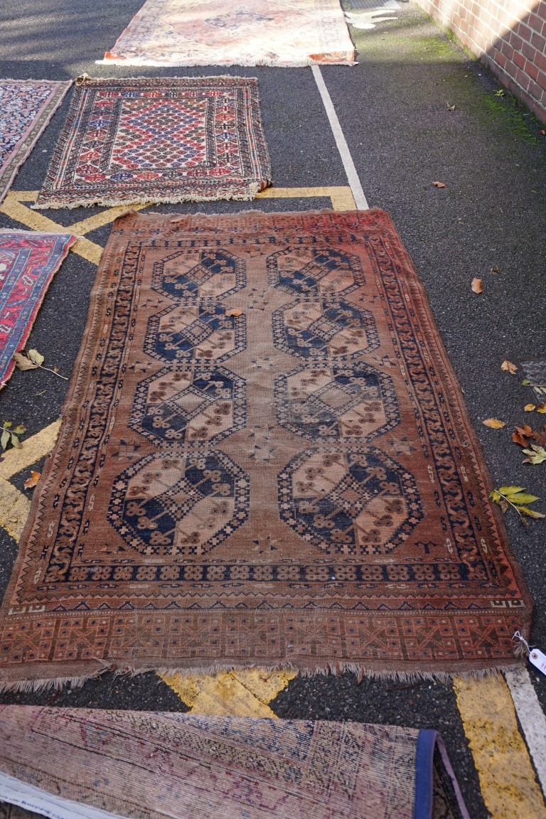 (THH) An Afghan rug, having eight central medallions, with geometric borders, 224 x 126cm.