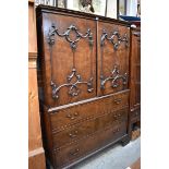 A George III mahogany linen press, in the manner of William Vile, the pair of relief moulded doors