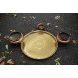 An eastern brass tray; together with three hammered copper bowls.This lot can only be collected on