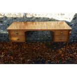 An Edwardian inlaid mahogany kneehole desk, (alterations), 130cm wide x 54.5cm deep x 76cm high.This
