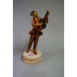 An Art Deco spelter Pierrot, on alabaster base, 23cm high.