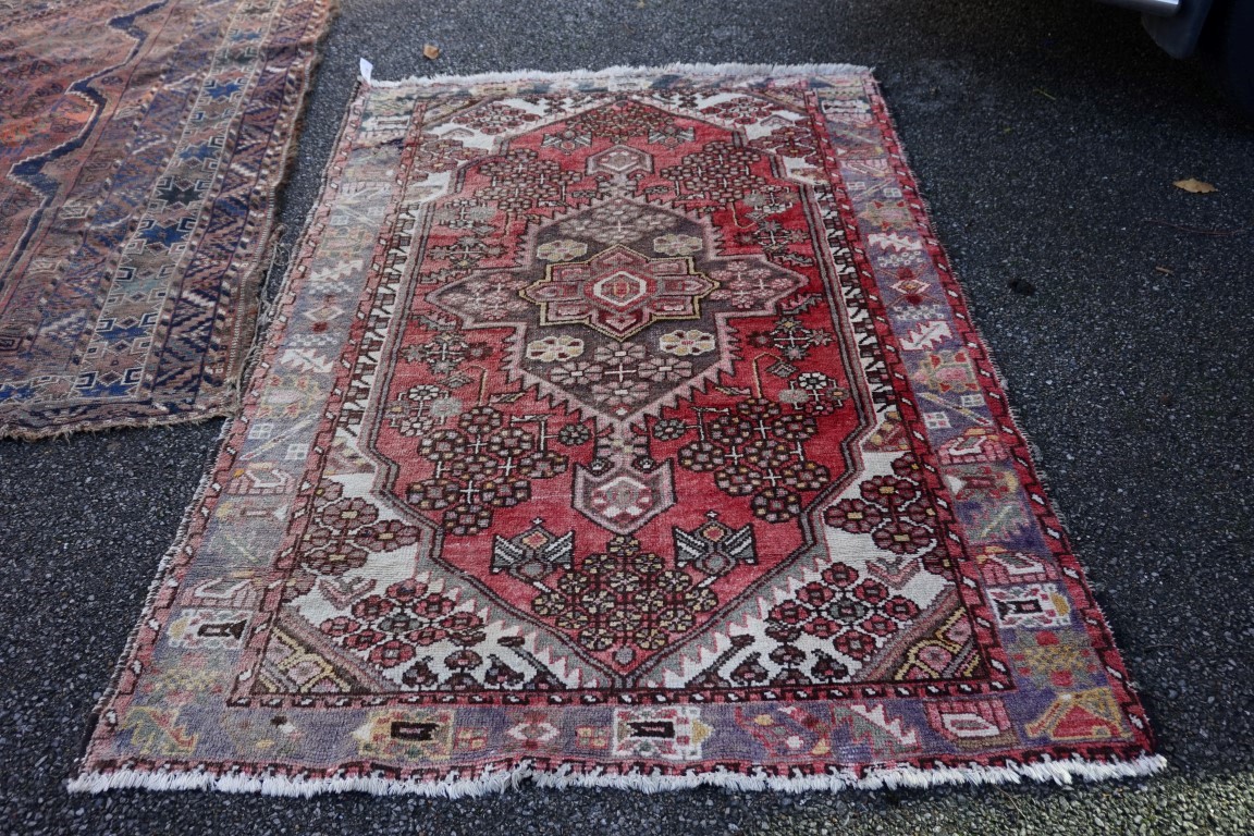 An old rug, having floral central medallion, with geometric borders, 198 x 138cm.