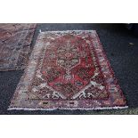 An old rug, having floral central medallion, with geometric borders, 198 x 138cm.