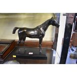 An antique bronze figure of a horse, 30.5cm high, on ebonized plinth.