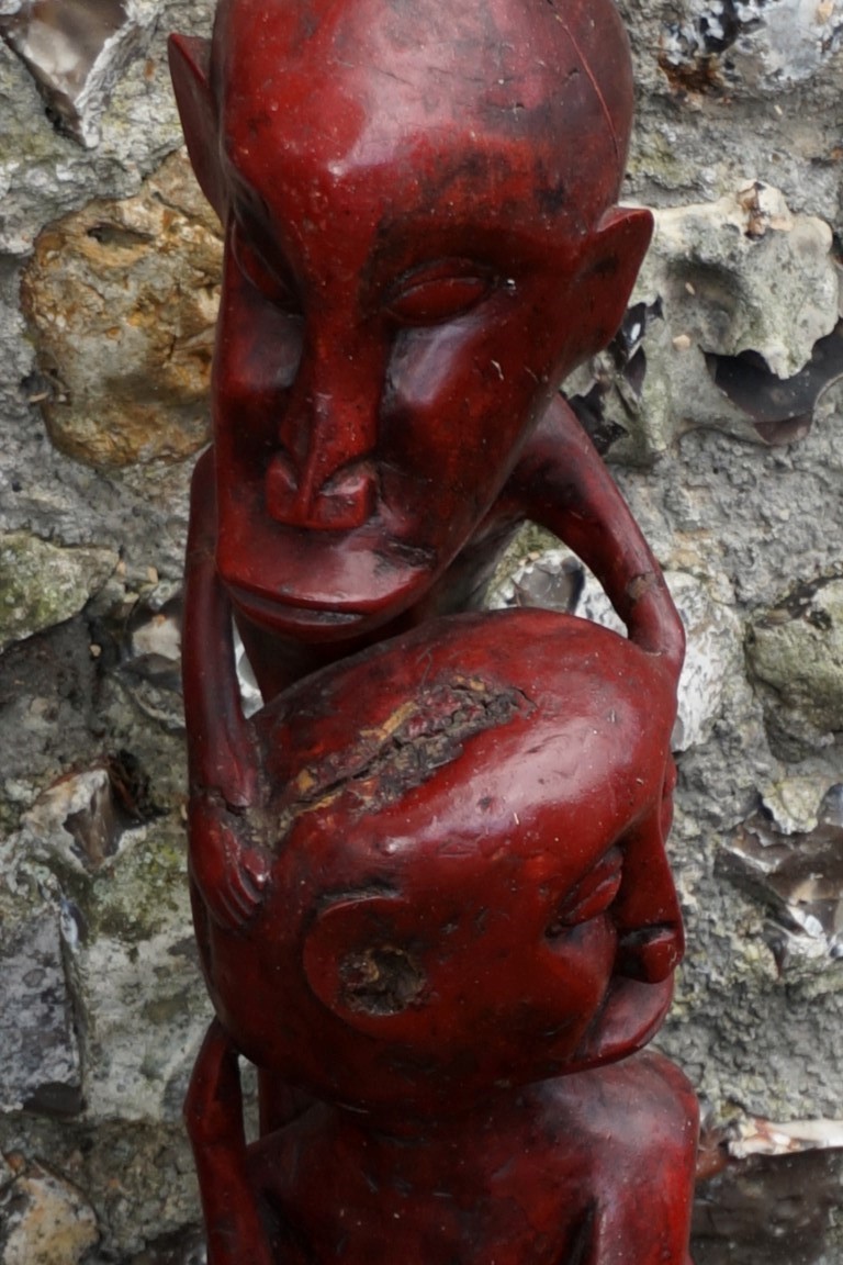 A red stained tribal figure; together with another figure; and a carved figure group. This lot can - Image 6 of 6