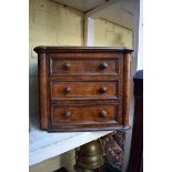 (THH) A Victorian walnut miniature three drawer chest, 32.5cm wide.