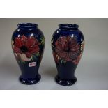 A pair of Moorcroft inverted baluster vases, tube lined with poppies, one numbered 16/200 and