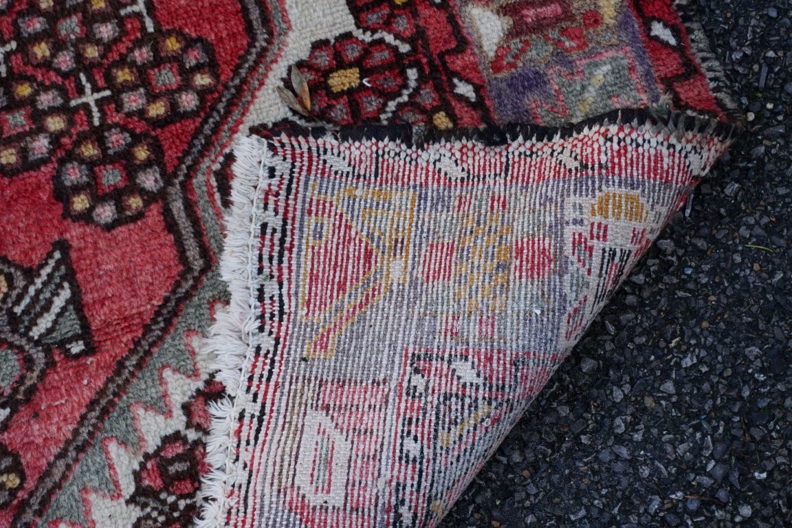 An old rug, having floral central medallion, with geometric borders, 198 x 138cm. - Image 2 of 2