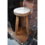 A beechwood three legged stool.