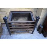 A neo classical style bronze and steel fire grate, 47.5cm high x 57cm wide.