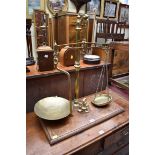A set of antique brass balance scales, on mahogany base, with five weights, 68cm high.