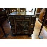 A late 17th century oak and walnut geometrically moulded small table cabinet, the hinged door