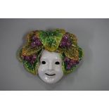 An Austrian Art Deco pottery wall mask, 16cm wide.