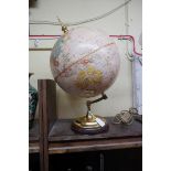 A Replogle 12in terrestrial globe, on brass and mahogany stand.