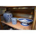 A 19th century blue and white pottery pedestal dish, 28cm wide, (restored); together with two