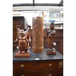 A Chinese carved wood figure of Guanyin, 30cm high; together with a carved bamboo vase, 36cm high;