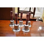 A set of five hand bells.