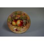 A small Royal Worcester cabinet plate, painted with fruit by H Ayrton, 18cm diameter, (hairline