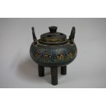 A Chinese bronze and cloisonne enamel twin handled tripod censer and cover, Qing, 17cm high.