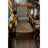 A circa 1900 mahogany and rush seated elbow chair.