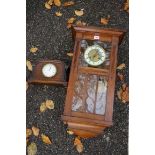 A mahogany hanging wall clock; together with an oak mantel clock. This lot can only be collected