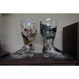 A pair of novelty glass boots, each painted with equestrian sporting scenes, 25.5cm high.