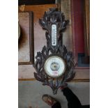 A Black Forest carved wood aneroid wall barometer, 47.5cm high.