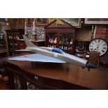 A vintage painted model of a Russian MiG jet plane, 103cm long.