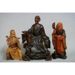 A Chinese carved and stained wood figure of Shoulao, on wood base, 18.5cm high; together with