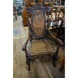 A good Charles II style carved walnut and cane open armchair.