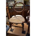 An antique walnut and rush seated child's chair.