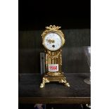 A Louis XI style brass mantel clock, with enamel dial, 18.5cm high.