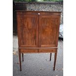An antique mahogany cupboard having pair of doors and two small drawers, 101cm wide, (converted to