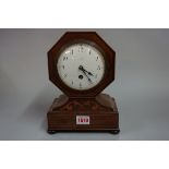 A circa 1900 mahogany and inlaid mantel timepiece, 24cm high, with pendulum.