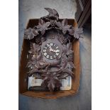 A Black Forest carved wood cuckoo clock, 65.5cm high, with weights.
